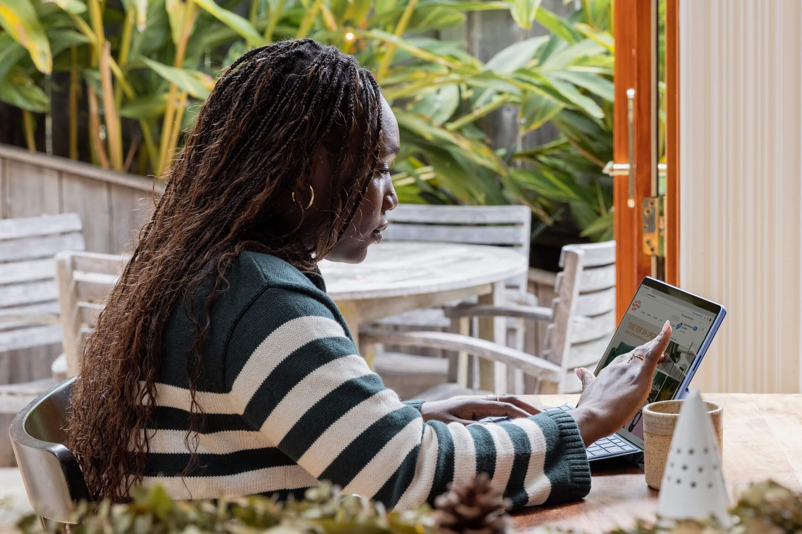 A person sitting at a table with a laptop.